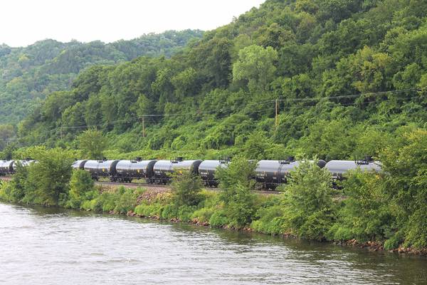 A crude oil train segment rumbles alongside a U.S. inland waterway. CREDIT: Dagmar Etkin