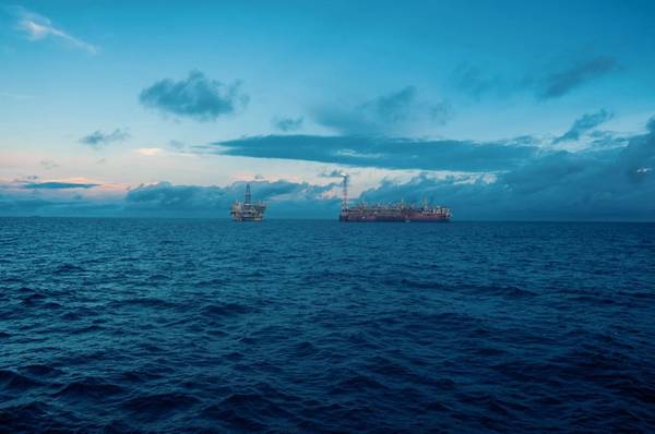 An FPSO next to an oil platform - Credit; Igor Kardasov/AdobeStock
