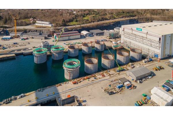 Hywind Tampen structures being floated out of the drydock at Stord, Norway. Photo from Aker Solutions / Lars Melkevik.